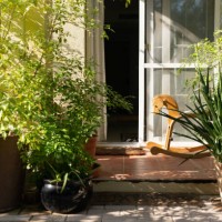 porch with potted plants and wooden rocking horse in a garden - garden decoration stock pictures, royalty-free photos & images