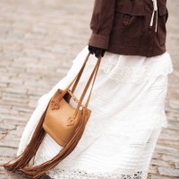 Pornwika Spiecker wears long white skirt, brown jacket and brown bag outside the Munthe fashion show during the Copenhagen Fashion Week Autumn/Winter...