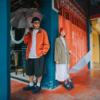 portrait asian chinese couple holding umbrella standing in corridor of penang old town shoplot - fashion stock pictures, royalty-free photos & images