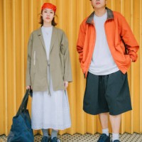 portrait asian chinese young couple with fashionable clothing standing in front of yellow metal gate - fashion stock pictures, royalty-free photos & images