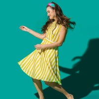 portrait carefree young woman in striped dress dancing against turquoise background - fashion stock pictures, royalty-free photos & images