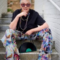 portrait, cool and funky mature woman with stylish and trendy fashion sitting on stairs outdoors. old, elderly and urban outfit by pensioner female with modern and colorful clothes on steps - fashion stock pictures, royalty-f