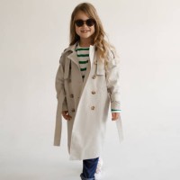 portrait of a beautiful fashionable girl with long blonde hair wearing sunglasses jeans and trench coats on a white background in the studio - fashion stock pictures, royalty-free photos & images