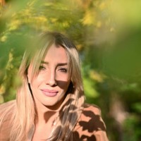 portrait of a beautiful smiling woman standing amongst trees in a park, bosnia and herzegovina - garden decoration stock pictures, royalty-free photos & images