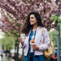 portrait of a beautiful woman having a coffee and breakfast on the street - junk food stock pictures, royalty-free photos & images