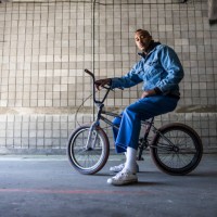 portrait of a bmx rider in warehouse environment - fashion stock pictures, royalty-free photos & images