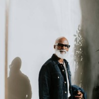 portrait of a confident older gentleman looking directly at the camera against a plain background - fashion stock pictures, royalty-free photos & images