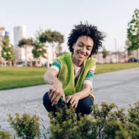 portrait of a female city gardener taking care of the park plants - garden decoration stock pictures, royalty-free photos & images