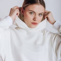 portrait of a female model in a hoodie on a white background - fashion stock pictures, royalty-free photos & images