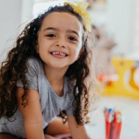 portrait of a smiling little girl at home - hairstyle stock pictures, royalty-free photos & images