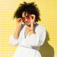 portrait of a woman against a yellow background - fashion stock-fotos und bilder