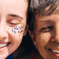 portrait of a woman senior and young resting with glitter on her face on a sunny summer day. close-up, half faces. - fashion stock pictures, royalty-free photos & images