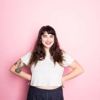 portrait of a woman with tattoos and red lipstick against a pink background - fashion stock pictures, royalty-free photos & images