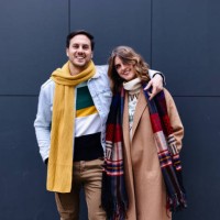 portrait of a young couple standing against dark grey background - fashion stock pictures, royalty-free photos & images
