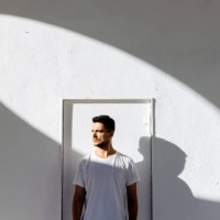 portrait of a young man in white t-shirt against white background - fashion stock pictures, royalty-free photos & images