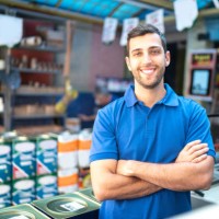 portrait of a young sales man standing in a paint store - home decoration stock pictures, royalty-free photos & images