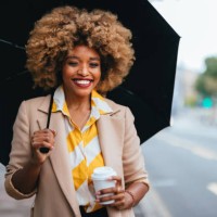 portrait of an elegant african american woman with paper cup standing on the street - junk food stock pictures, royalty-free photos & images