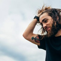 portrait of bearded young man with tattoo on his upper arm - fashion stock pictures, royalty-free photos & images