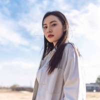 portrait of beautiful young woman, casual clothes and backpack, walking on the dry grass, looking at the camera and smiling - fashion stock pictures, royalty-free photos & images