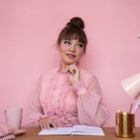 portrait of businesswoman in ruffled blouse sitting at desk - home decoration stock pictures, royalty-free photos & images