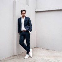 portrait of confident businessman leaning against a wall - fashion stock pictures, royalty-free photos & images