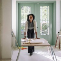 portrait of confident female architect leaning on table at under construction apartment - home decoration stock pictures, royalty-free photos & images