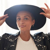 portrait of confident young woman holding hat - fashion stock pictures, royalty-free photos & images