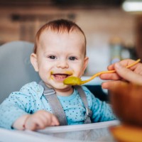 portrait of cute little baby boy eating his lunch. - food stock pictures, royalty-free photos & images