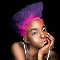 portrait of eccentric young woman with pink and purple dyed hair in front of black background - hairstyle stock pictures, royalty-free photos & images