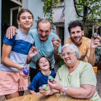 portrait of family decorating easter eggs together at home - garden decoration stock pictures, royalty-free photos & images