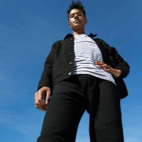 portrait of fashionable man standing against blue sky - fashion stock pictures, royalty-free photos & images