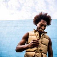 portrait of fashionable young man in front of bright blue wall - fashion stock pictures, royalty-free photos & images