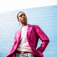 portrait of fashionable young woman in front of bright blue wall - fashion stock pictures, royalty-free photos & images