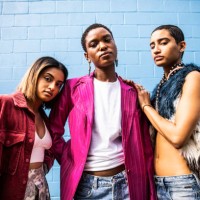 portrait of fashionable young women in front of bright blue wall - fashion stock pictures, royalty-free photos & images