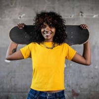 portrait of female skateboarder in warehouse environment - fashion stock pictures, royalty-free photos & images