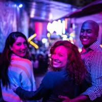 portrait of friends embracing at nightlife - including a transgender person - concert stock pictures, royalty-free photos & images