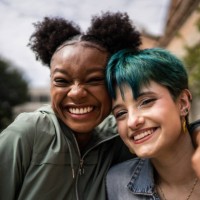 portrait of friends embracing in the street - fashion stock pictures, royalty-free photos & images