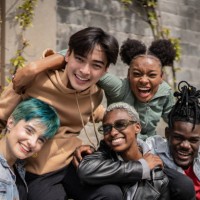 portrait of friends sitting in a bench outdoors - fashion stock pictures, royalty-free photos & images