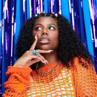 portrait of genz woman standing in front of a blue and purple metallic curtain background. - fashion stock pictures, royalty-free photos & images