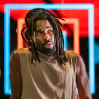 portrait of handsome black man in front of colorful neon lights - fashion stock pictures, royalty-free photos & images