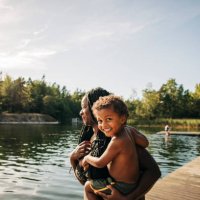 portrait of happy boy in mother arms during vacation - travel stock pictures, royalty-free photos & images