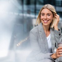portrait of happy young businesswoman with takeaway coffee in the city - junk food stock pictures, royalty-free photos & images
