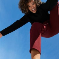 portrait of happy young woman against blue sky - fashion stock pictures, royalty-free photos & images