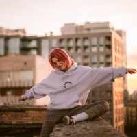 portrait of happy young woman sitting on the roof at sunset - fashion stock pictures, royalty-free photos & images