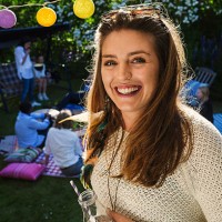 portrait of happy young woman with friends in background at yard during summer party - garden decoration stock pictures, royalty-free photos & images