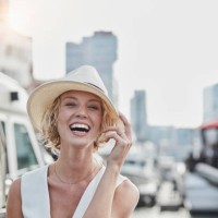 portrait of laughing young woman wearing a hat at a marina - fashion stock pictures, royalty-free photos & images