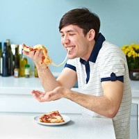 portrait of man eating pizza - junk food stock pictures, royalty-free photos & images