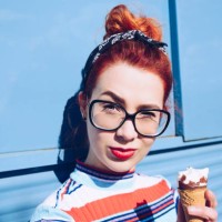 portrait of redhead young woman holding ice cream cone against mini van - fashion stock pictures, royalty-free photos & images