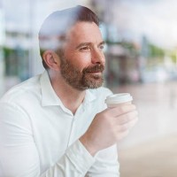 portrait of relaxed businessman looking through window of coffee shop - junk food stock pictures, royalty-free photos & images