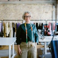 portrait of senior female fashion designer in design studio - fashion stock pictures, royalty-free photos & images